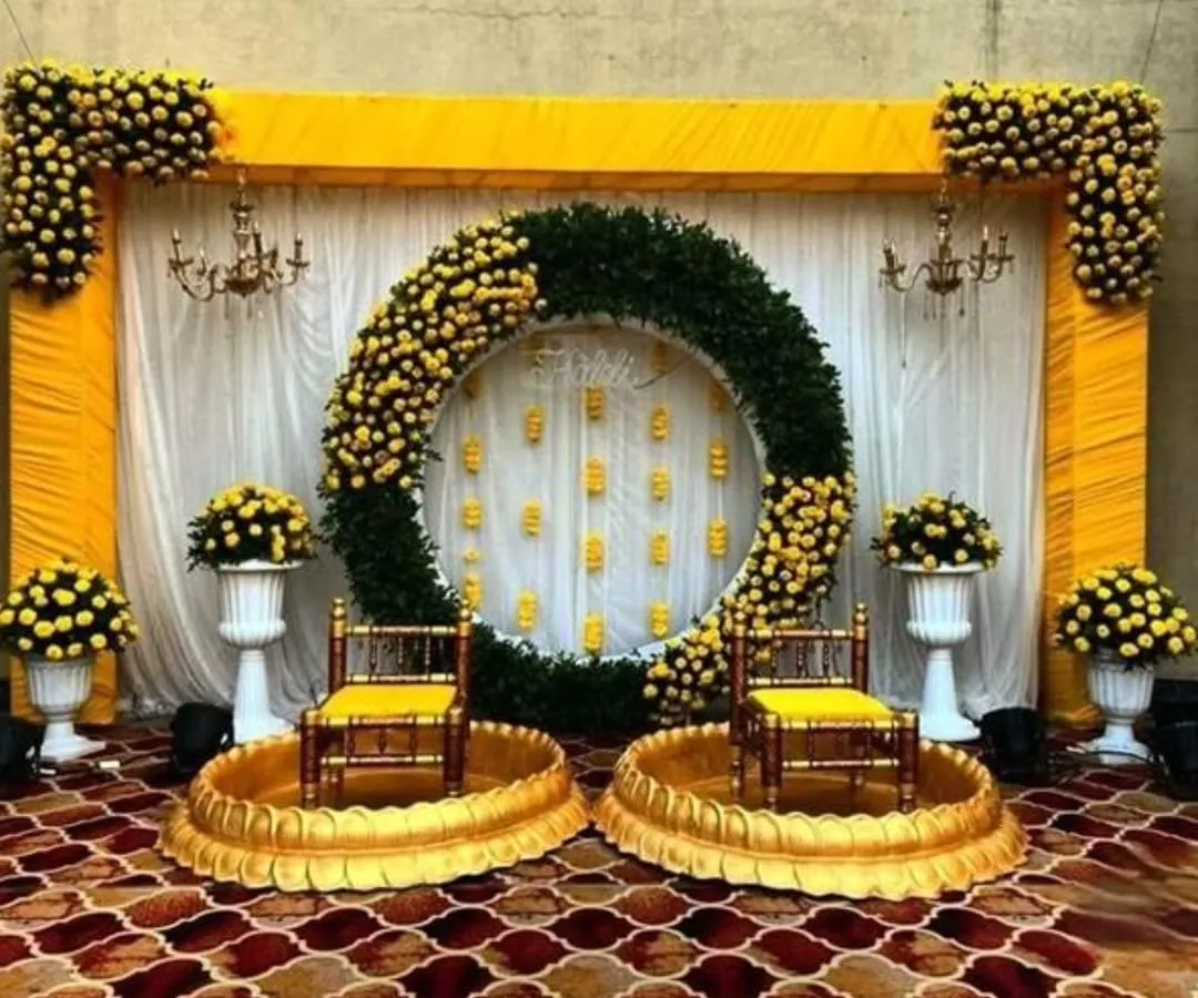 I love creating vibrant and grand setups for Haldi ceremonies. This design uses a massive ring of marigolds and lush greens to create a spectacular focal point for your celebration.