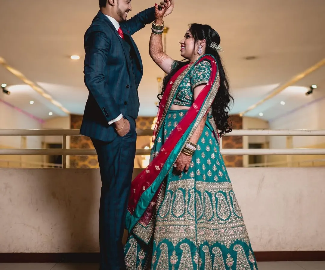 For a reception, we can create a more glamorous and contemporary look. Here, I styled the bride with a sophisticated updo and bolder makeup to complement her ornate lehenga, ensuring she looked stunning for her evening celebration with her partner.