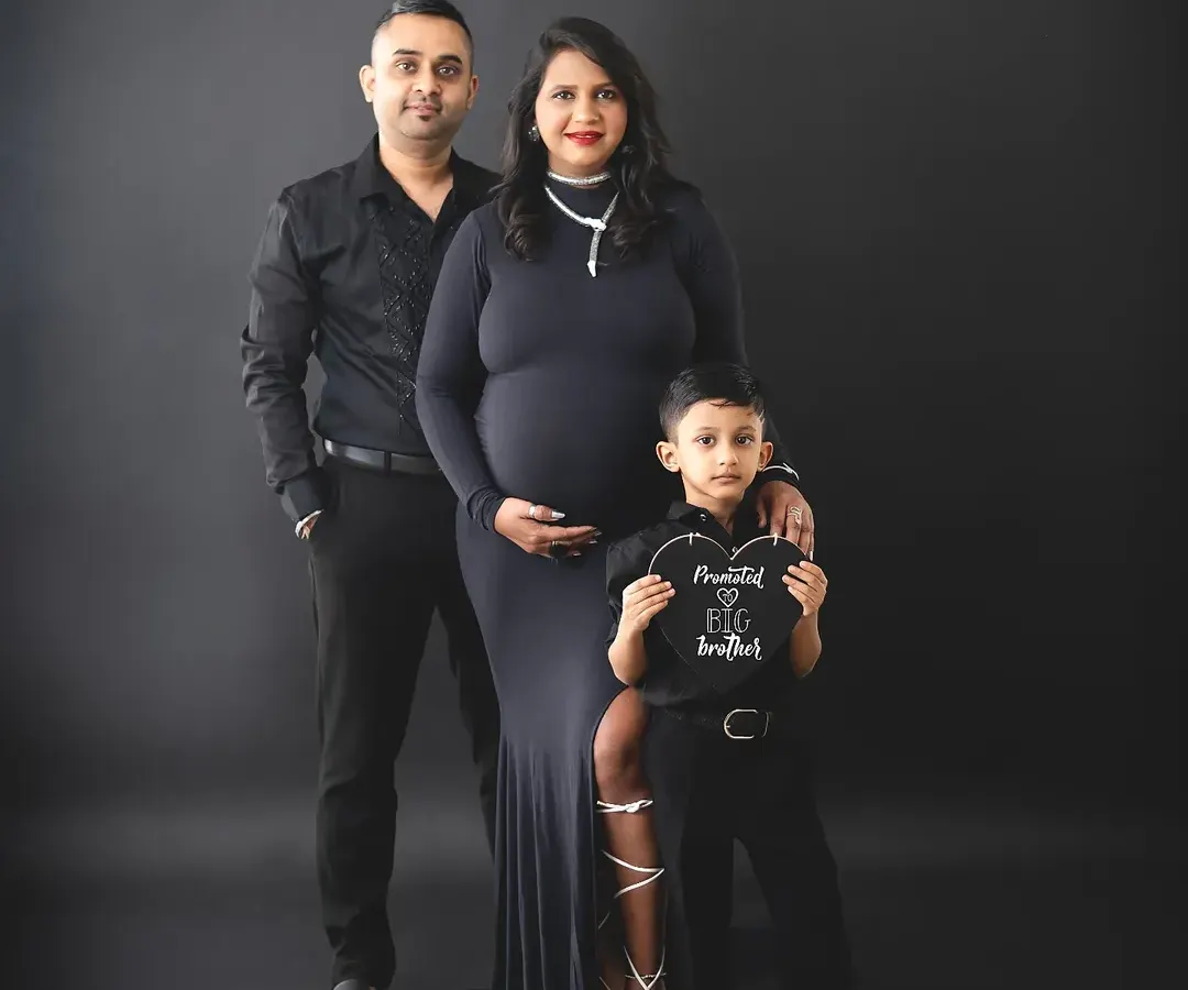 The whole family gets to share in the excitement. We love capturing these moments, like a big brother getting ready for his new role. Our studio can create these classic, dramatic family portraits that feel both modern and timeless.
