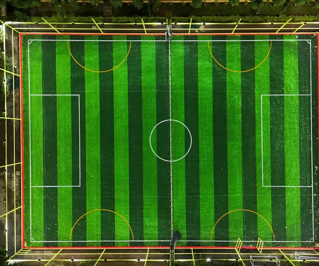 An aerial view of our pristine, floodlit football turf in JP Nagar. This is the perfect pitch for your 5v5 or 7v7 matches, day or night. The professional-grade turf is ready for your crew's next big game.