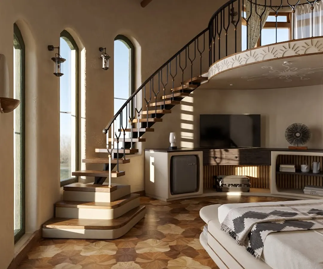 Inside the guest suites, I created multi-level spaces to add dimension and surprise. This duplex room features a gracefully curving staircase and intricate wooden flooring, with large arched windows that flood the room with natural light and connect guests to the views outside.