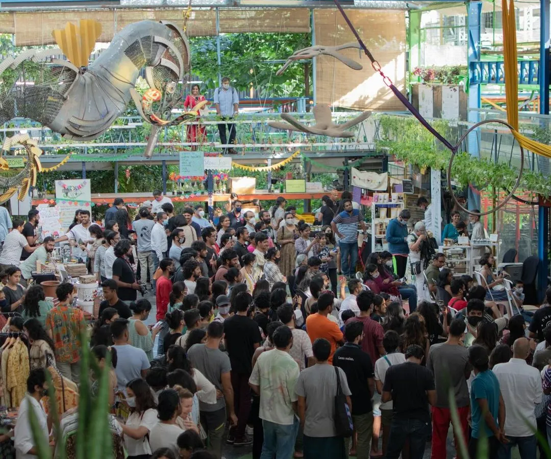 A wide-angle view from above showing our Central Arena packed with a large, engaged crowd during a bustling market event. This demonstrates the scale and vibrant atmosphere our venue can accommodate.