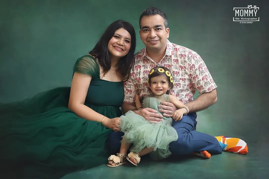 A perfect family portrait. I love how their coordinated green outfits look against the studio backdrop, and the pure happiness on their faces says it all. This is what treasuring your family looks like.