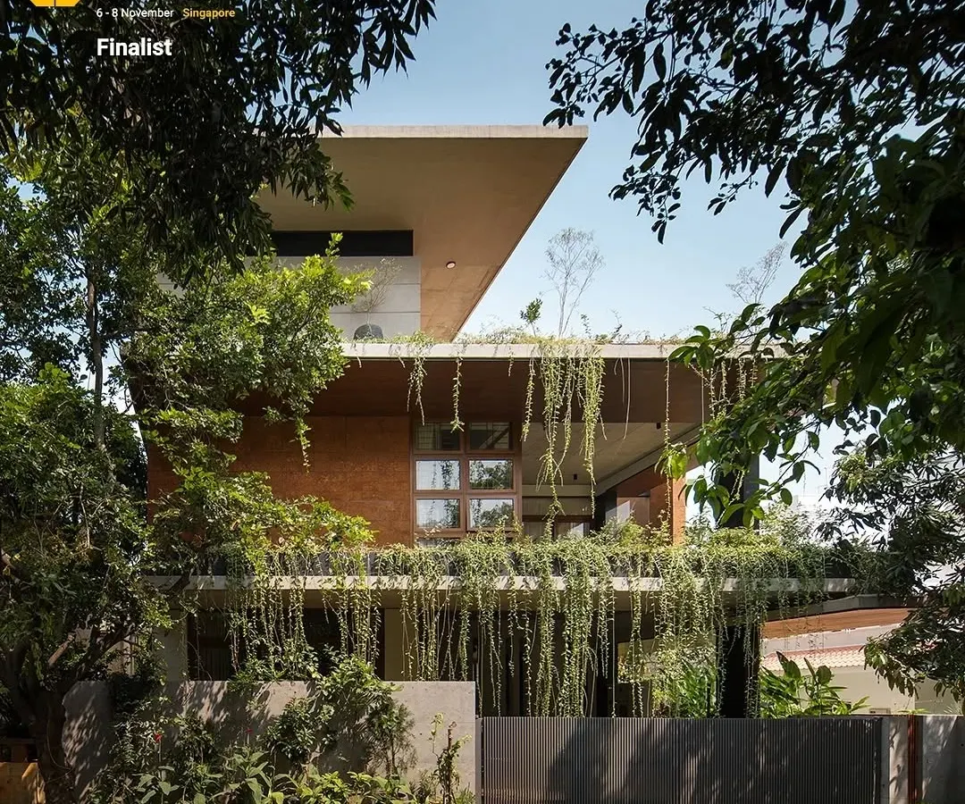 The exterior of the 'House of Greens' showcases my passion for biophilic architecture. Cascading greenery drapes over the concrete facade, creating a living skin that cools the home and blurs the boundary between the building and the landscape. This approach turns a simple residence into a natural sanctuary within the city.