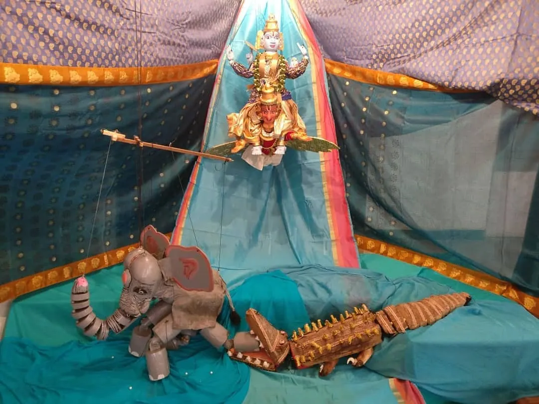 A scene from the Gajendra Moksha story, depicted with our handcrafted puppets. This display showcases the intricate detail and expressive artistry that goes into each character, from the divine form of Vishnu to the elephant and crocodile.