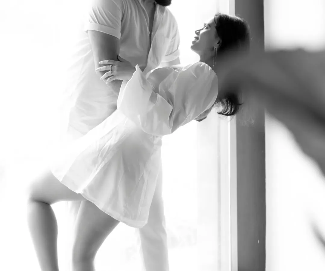 This is what I mean by capturing a story. In this black and white pre-wedding portrait, the focus is entirely on the couple's connection, the playful dip, and the genuine joy in their expressions. It's an intimate, timeless moment captured forever.