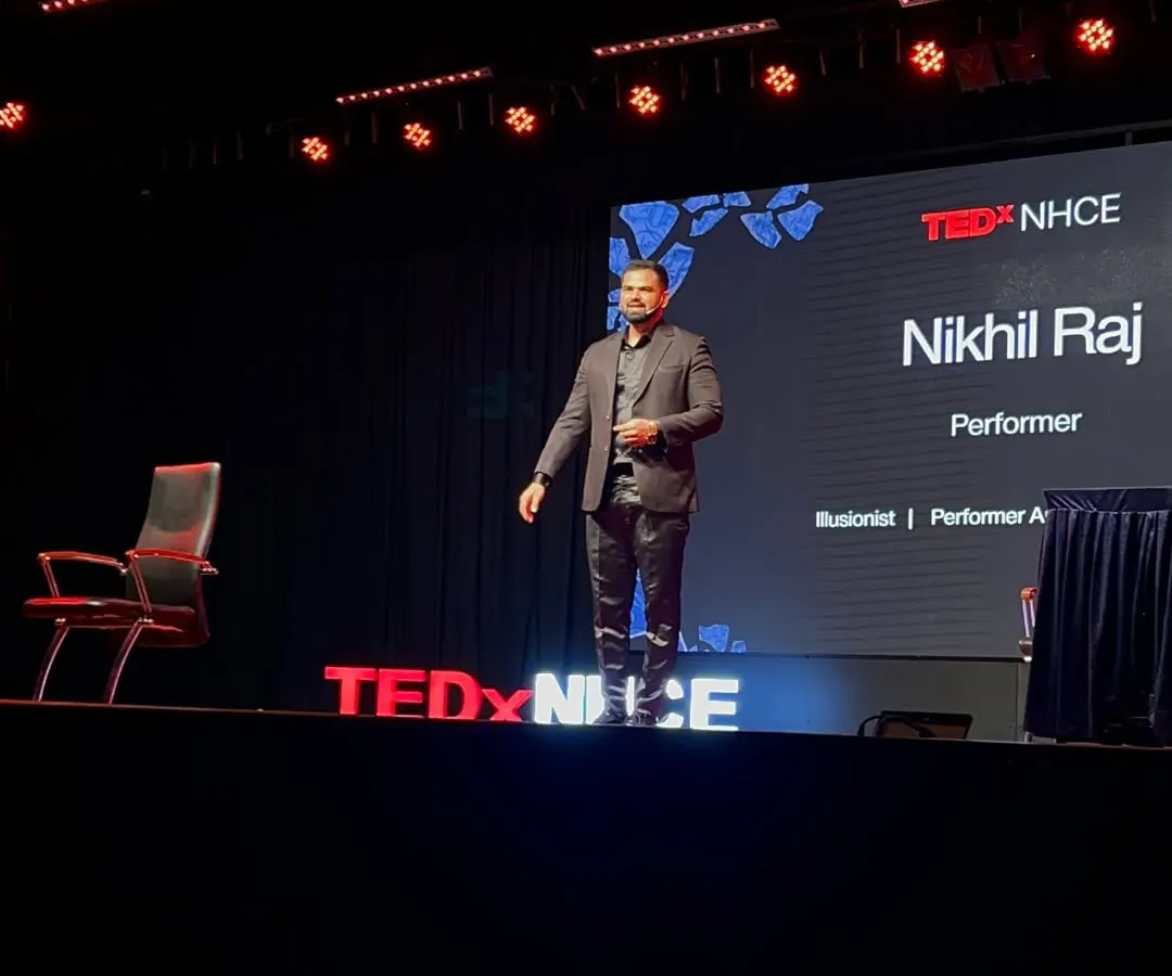 On the iconic red circle, delivering a talk at TEDxNHCE. Being a four-time TEDx speaker has honed my ability to blend complex ideas with illusion, creating keynote presentations that are both engaging and deeply memorable for any corporate audience.