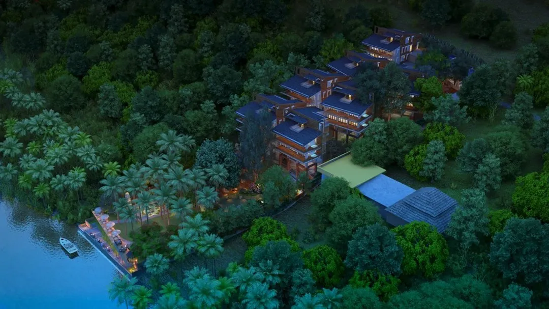 An aerial view of the Atmanya boutique resort in Goa at dusk, a design that harmonizes with its lush, waterfront landscape to create a tranquil and immersive natural retreat.