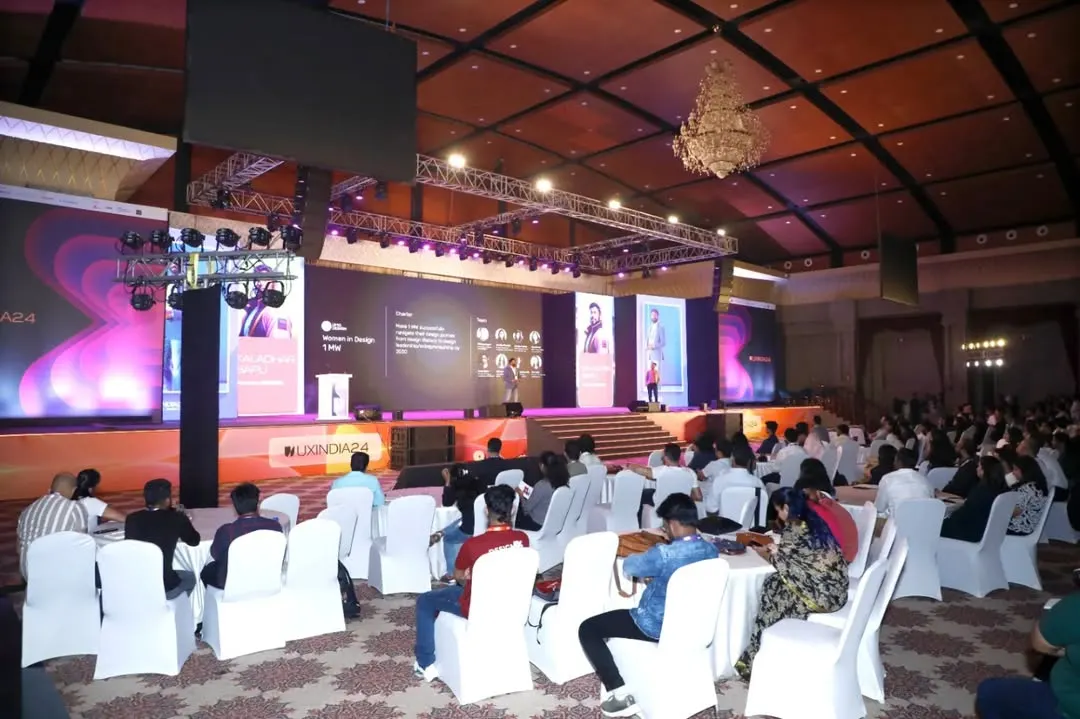 We excel at capturing the full scale of your event. This wide-angle shot of the UXINDIA 2024 summit shows the large, engaged audience and the professional stage production, demonstrating our capacity for covering major conferences.