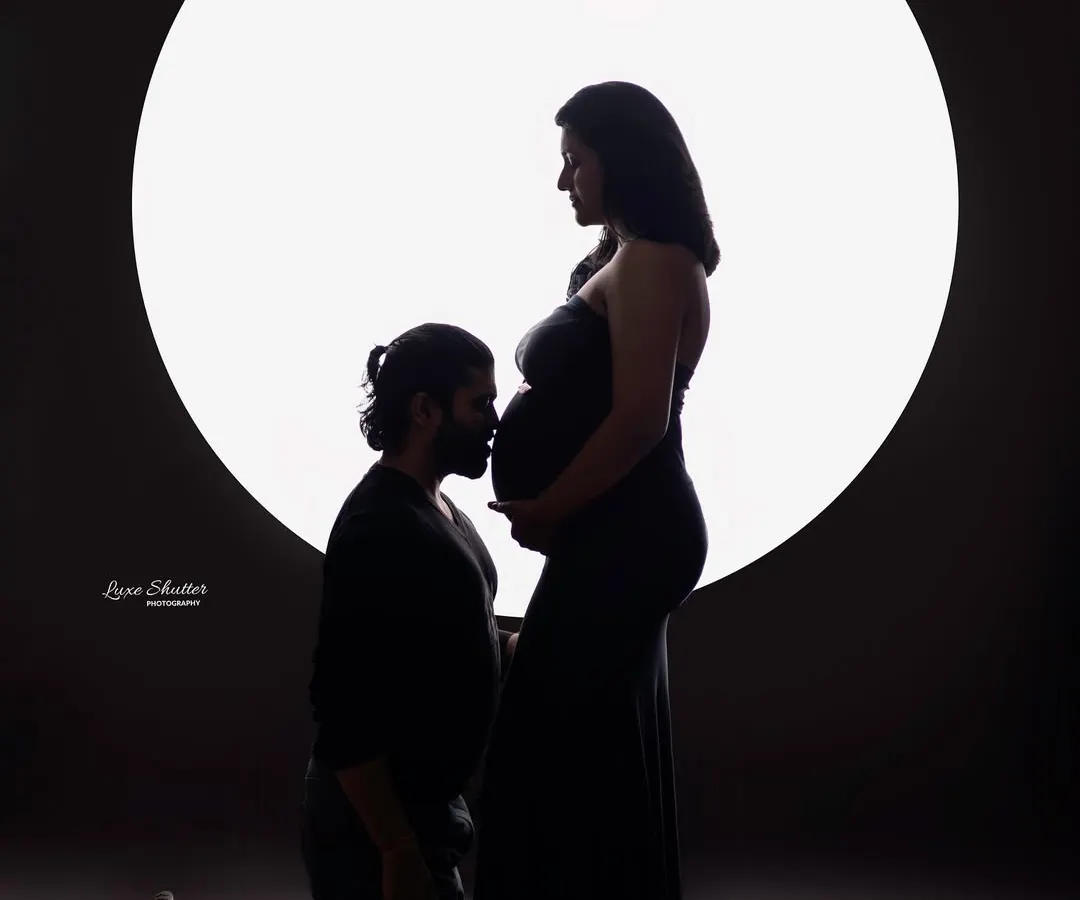 A timeless silhouette portrait that speaks volumes without a word. I love using dramatic lighting to focus on the beautiful connection between a couple and the new life they are waiting for.