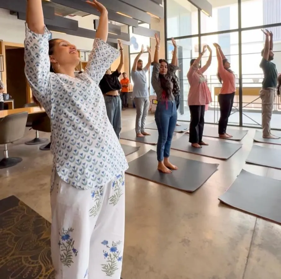 The joy on everyone's face says it all. This is a moment from a corporate yoga session where we focused on simple, uplifting stretches to release tension from the neck, shoulders, and back. You can see how accessible and enjoyable it is for the whole team.
