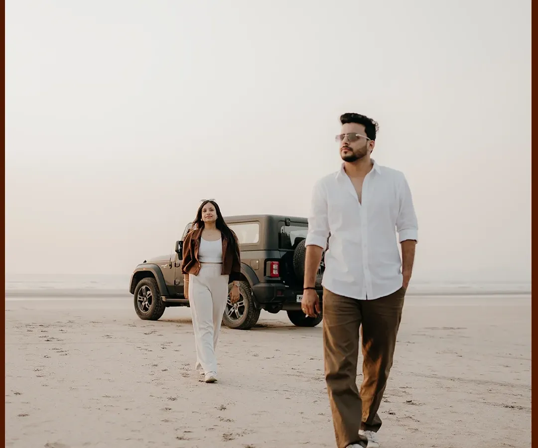 For the adventurous couple, your love story is a journey. Here, we created a modern, editorial-style shot with their Mahindra Thar on the beach, capturing their cool, free-spirited connection.