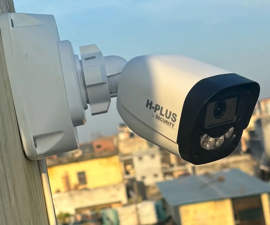 A close-up of an H-Plus Security bullet camera installed for rooftop surveillance in Ghitorni, New Delhi. Its position provides a wide, unobstructed view, perfect for monitoring large outdoor areas day and night.