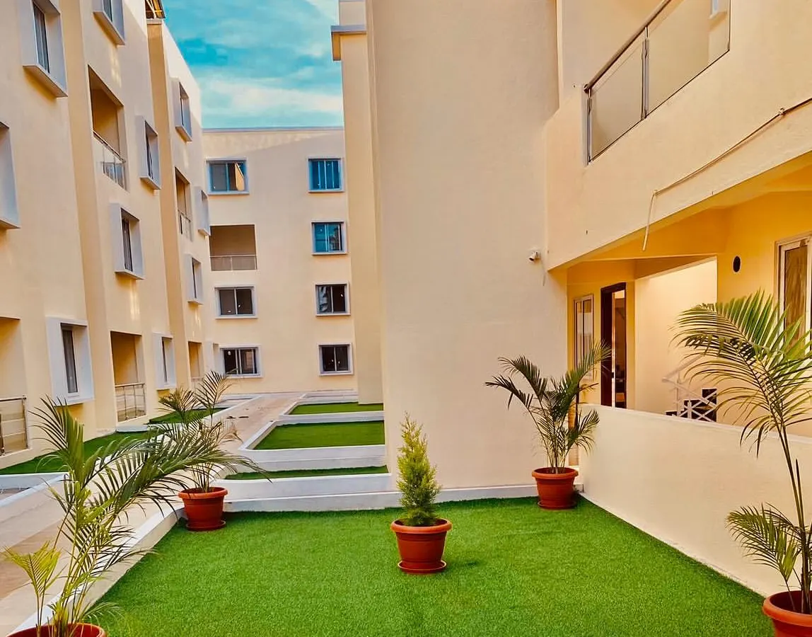 This apartment balcony was converted into a lush, green retreat. I used high-quality artificial turf for the flooring and added potted faux palm plants to create a maintenance-free garden space that can be enjoyed all year round, perfect for city living.