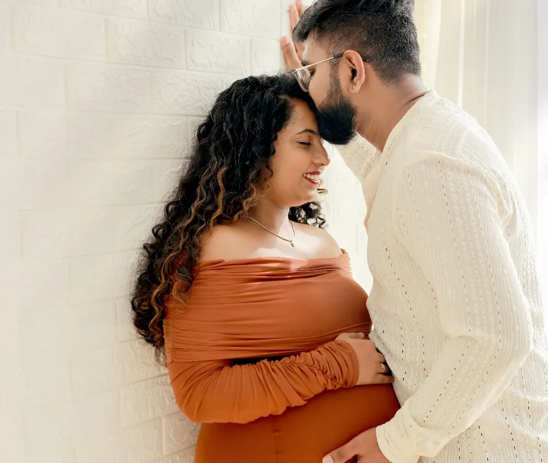We focus on capturing the quiet, intimate moments between expecting parents. This high-key couple portrait highlights the connection and joy of your journey together in our comfortable studio setting.