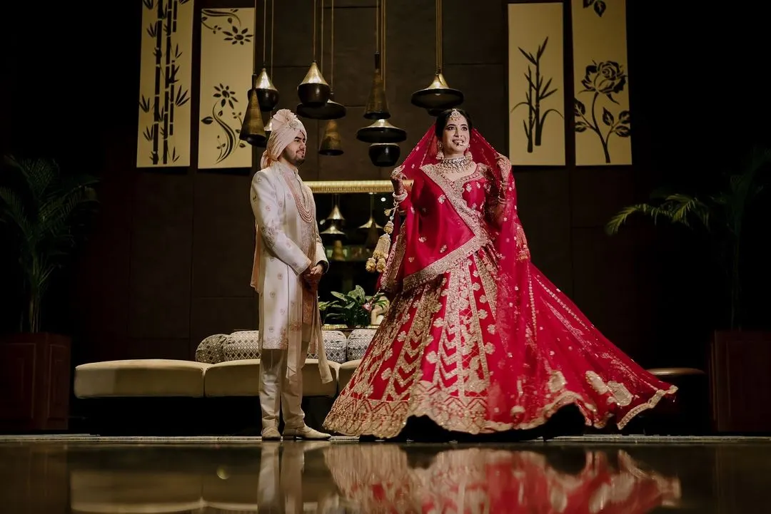 A classic portrait from Ritish and Aastha's wedding day in Delhi. I aim for timeless elegance in my couple portraits, creating images that feel both grand and personal. The bride's stunning red lehenga and the groom's coordinated sherwani made for a truly regal shot.
