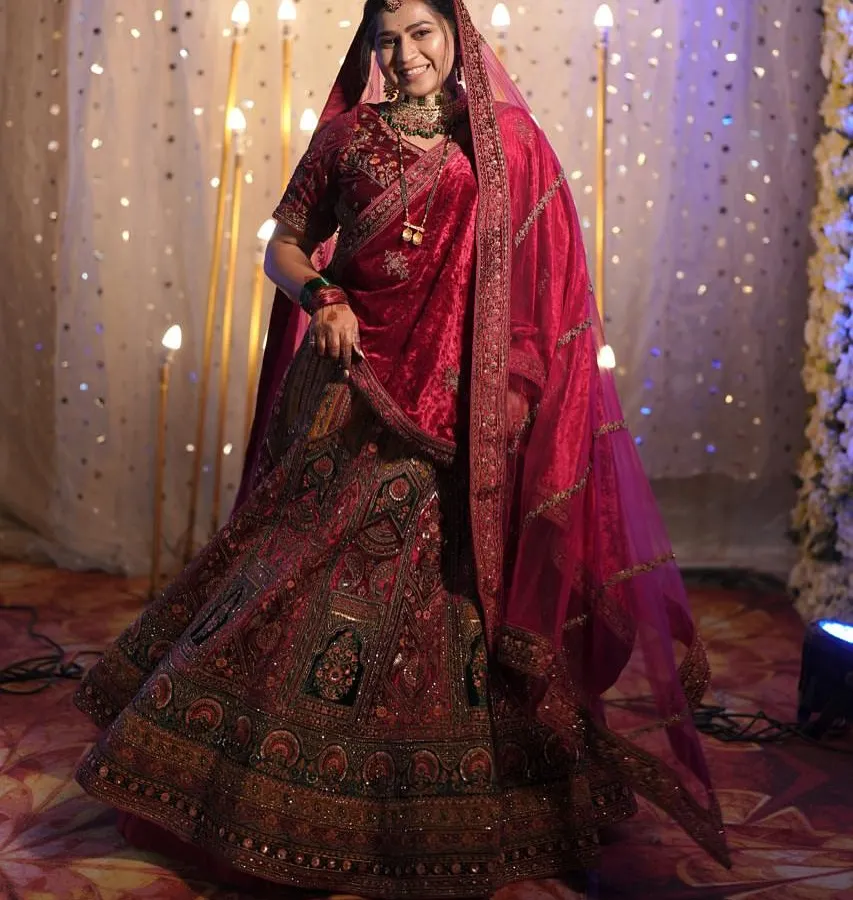 Here is to the bride in all her glory. This classic red bridal lehenga features intricate embroidery and a timeless silhouette, perfect for making your grand entrance on your wedding day.