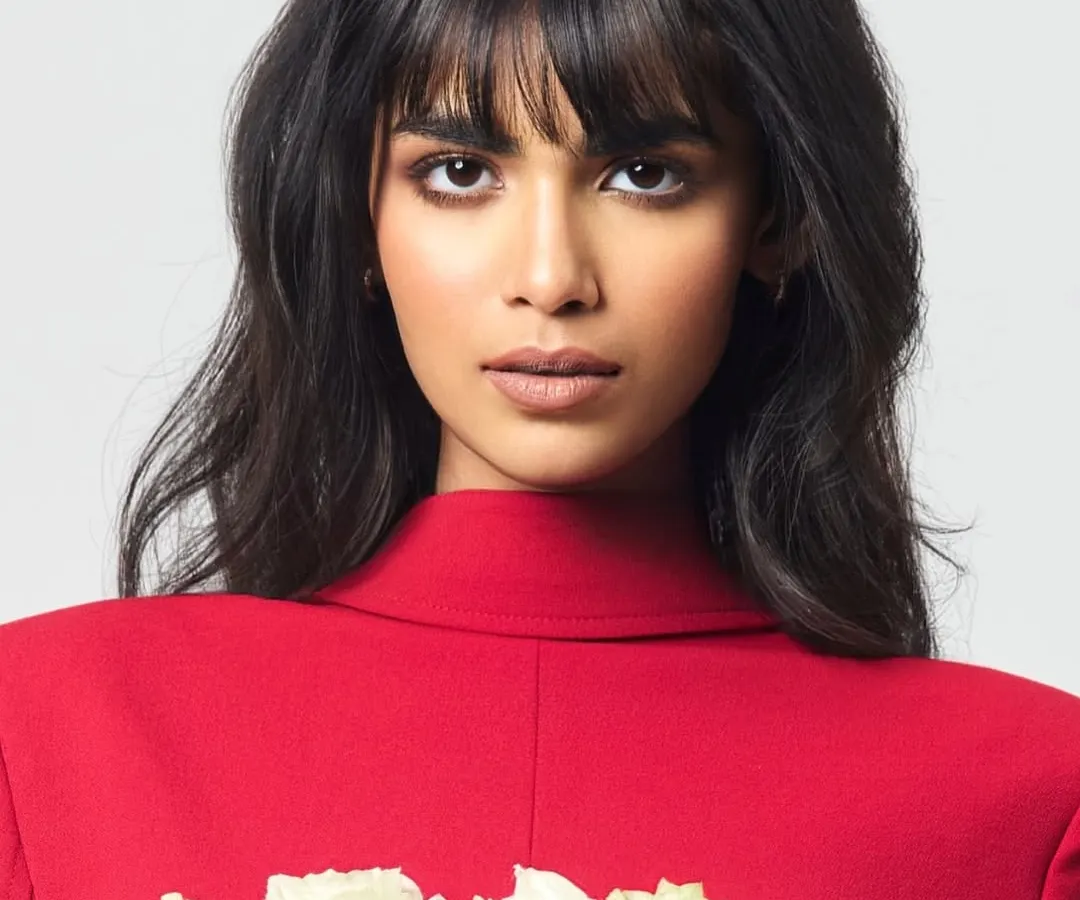 A close-up from an editorial feature where the brief was 'bold yet graceful'. I focused on a sharp, smoked-out eye and a soft nude lip to complement the model's strong features and the vibrant red styling, creating a powerful and memorable image.