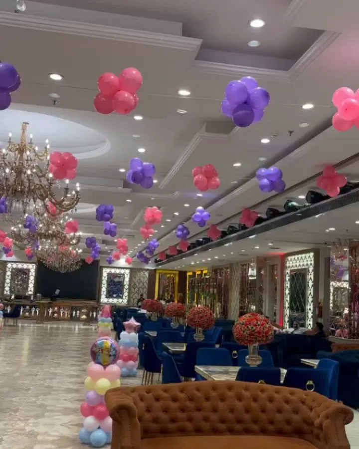 For Kridha's first birthday, I transformed this large banquet hall with a princess theme. I used floating clusters of pink and purple balloons across the ceiling to create a magical atmosphere for the celebration.