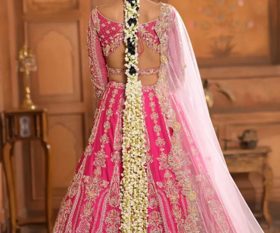 A full-length view of a classic South Indian bridal braid, generously adorned with fragrant jasmine flowers (gajara). This timeless hairstyle is perfect for traditional ceremonies and is designed to look elegant from every angle.