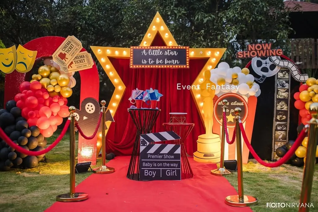 Announcing the arrival of a little star with a 'Lights! Camera! Baby!' themed baby shower. This fun, glamorous setup includes a red carpet entrance, a marquee star, and movie-themed props, making the parents-to-be feel like true celebrities.