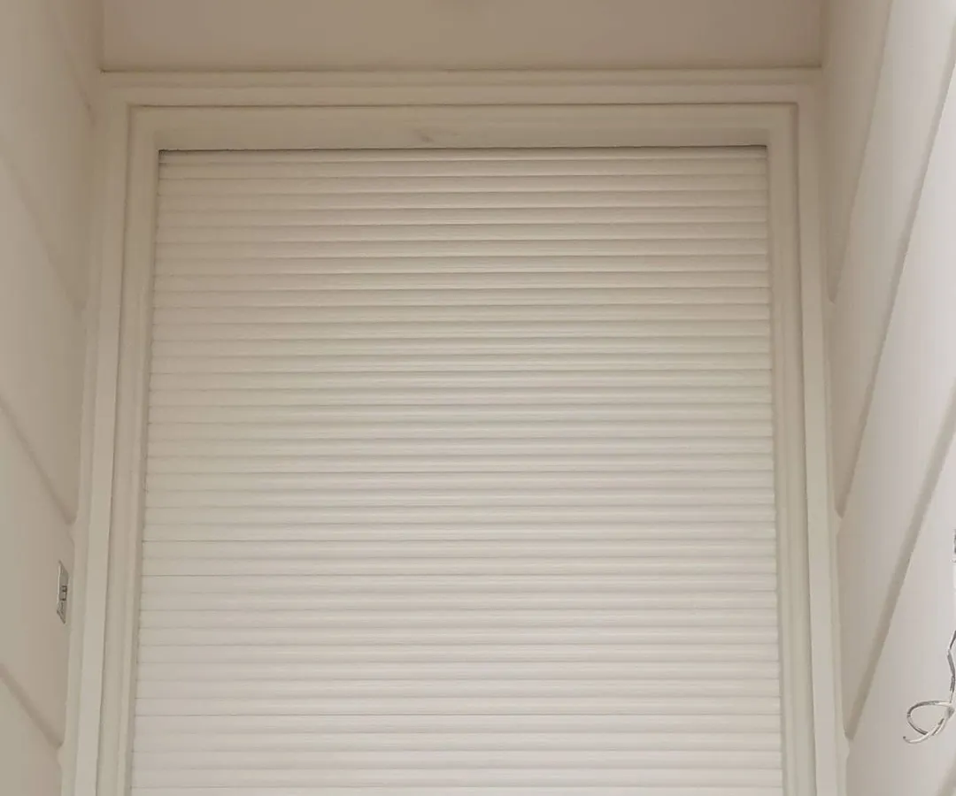 Here is a security sensor installed above a shop's rolling shutter. This is a key part of my wireless alarm system for businesses. If anyone tries to open the shutter after hours, the alarm will trigger and you get an instant call and SMS on your phone.