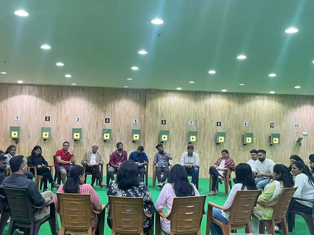 A corporate team building session is more than just target practice. Here, we gather a group for a briefing and discussion on the range, fostering communication and shared focus before the hands-on shooting experience begins.