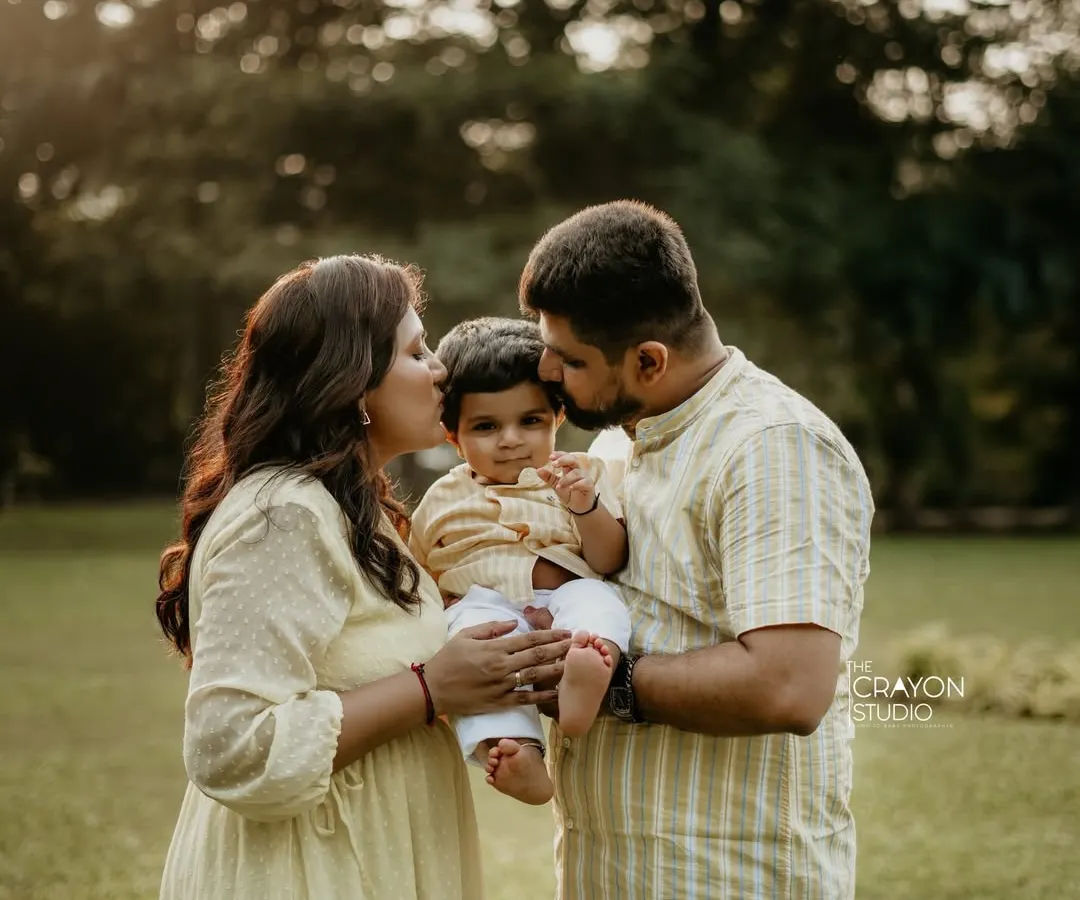 In a beautiful outdoor setting, I capture the unposed kisses and gentle embraces that define your family's love story. This is the warmth and connection that makes a family portrait timeless.
