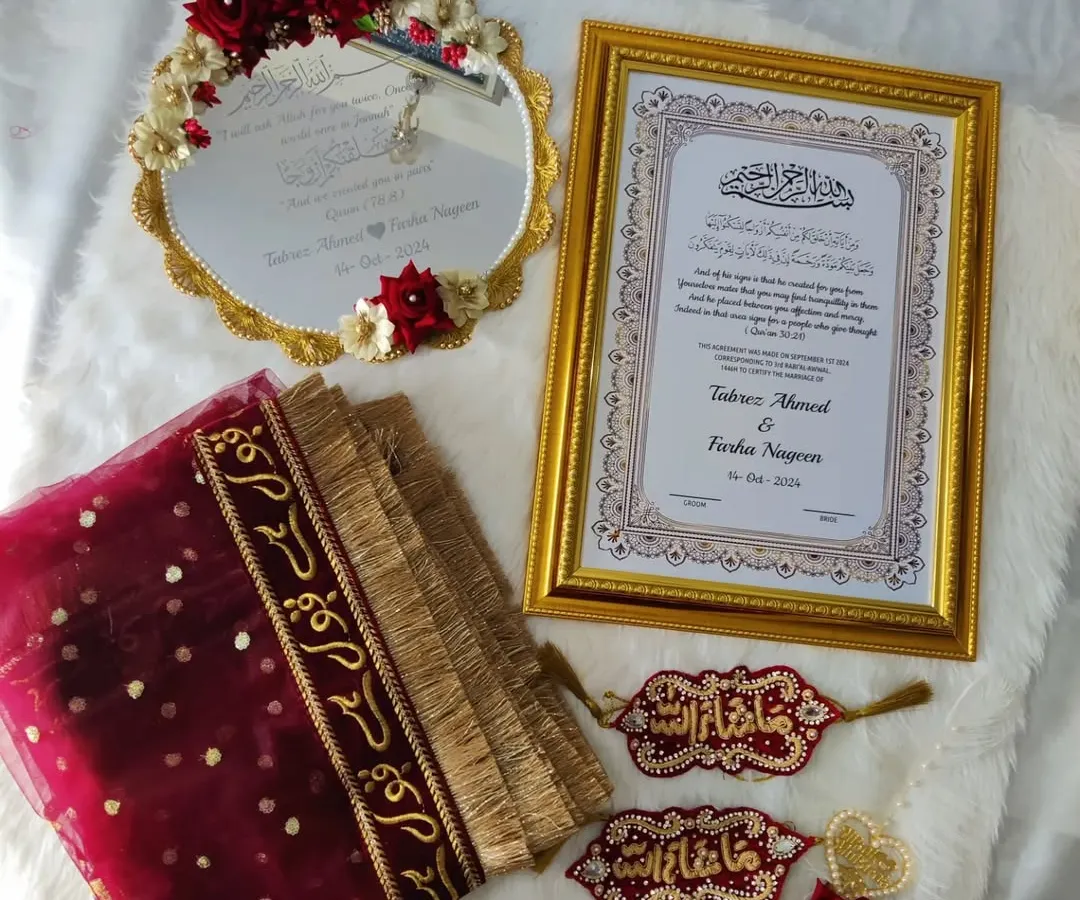 This is one of my complete Nikah sets, and it’s one of my babies. It includes a personalized framed Nikah Nama, a 'Muah Dekhaye' mirror, a 'Qubool Hai' dupatta, and beautifully detailed 'Masha-Allah' hangings. Everything is coordinated in rich maroon and gold to bring a royal touch to your ceremony.