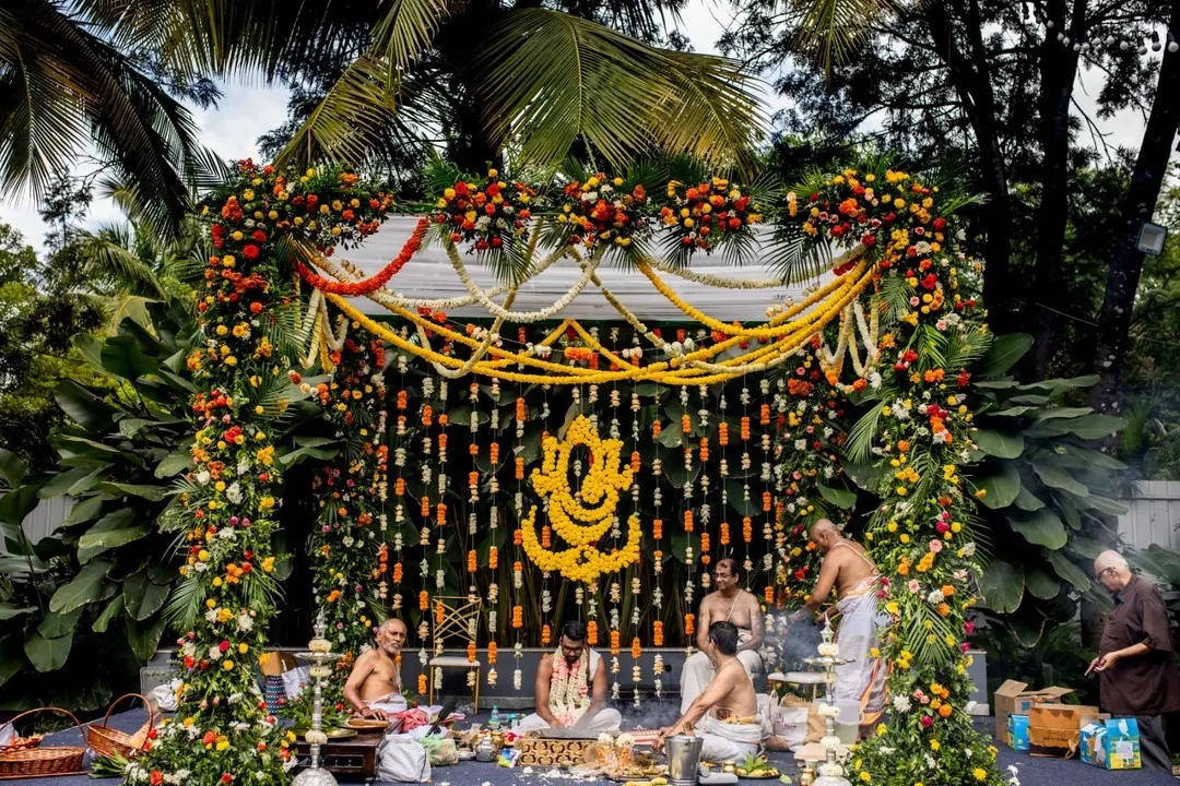 For this traditional Hindu wedding, we designed a magnificent mandap featuring a Ganesha motif made entirely of marigolds, surrounded by lush floral garlands to create a sacred and vibrant space.