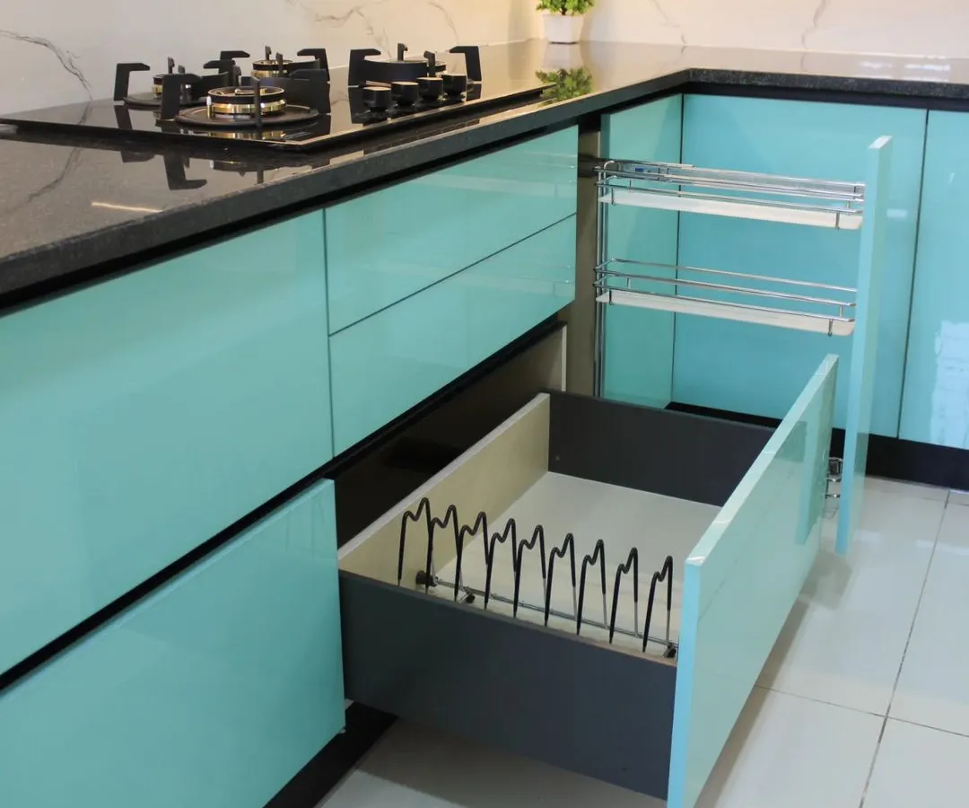 We believe in beauty that is also practical. This image showcases our smart storage solutions, including a multi-tiered pull-out spice rack and a deep drawer with a custom plate organizer, ensuring everything has its place.