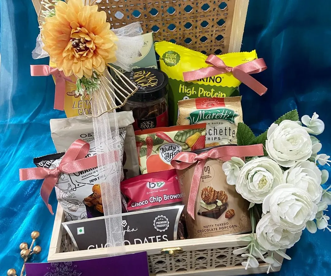 We believe in making festivals memorable. This Diwali hamper, set in a beautiful cane and wood box, is filled with gourmet snacks and treats, all elegantly wrapped and ready to delight your loved ones.