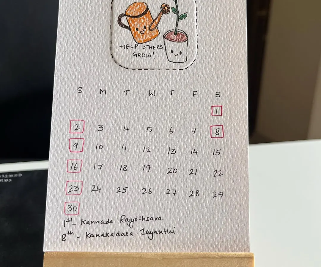 Here’s a close-up of my 2025 hand-drawn desk calendar. Each month features a unique, punny doodle on eco-friendly, recycled paper, and it comes with this cute little wooden easel to sit perfectly on your desk.