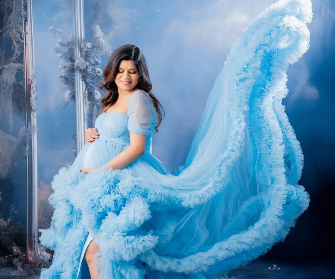I love creating dynamic and dreamy portraits. The flowing fabric of this light blue gown adds a sense of movement and fantasy, making for a truly ethereal maternity photo.