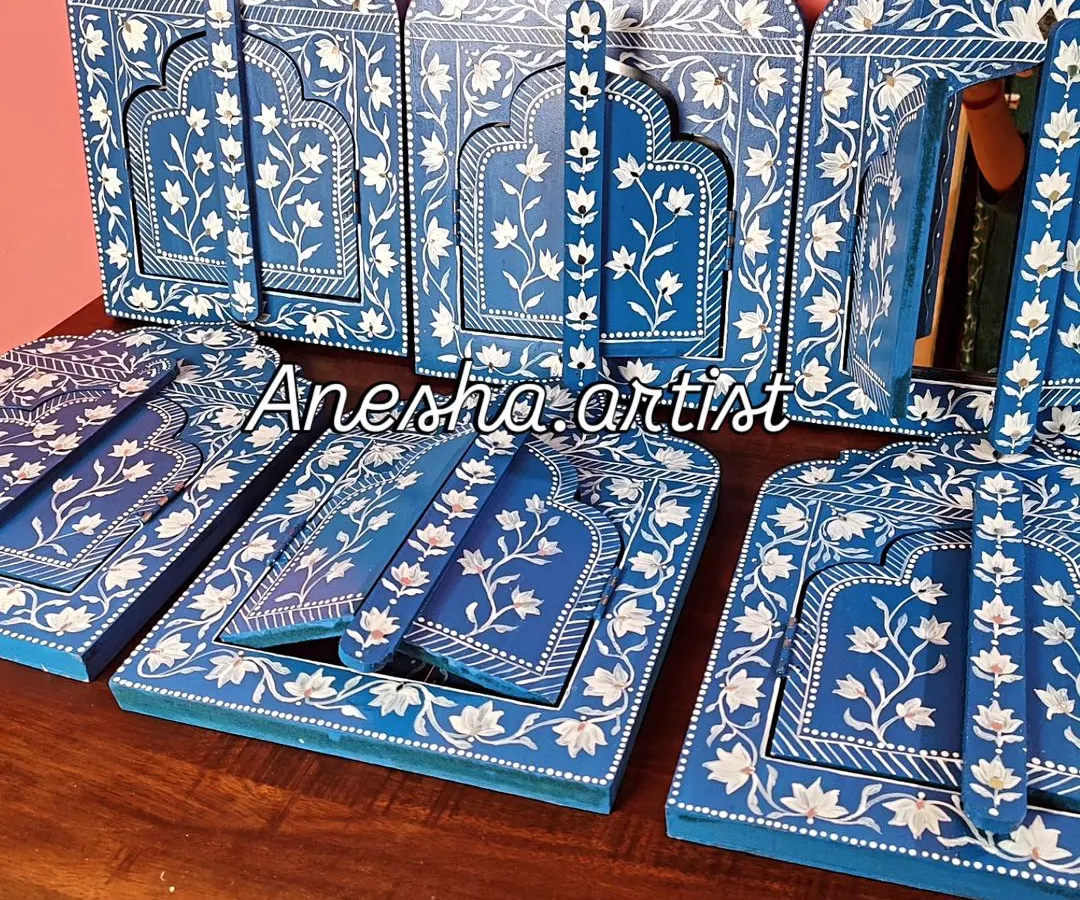 Inspired by the royal palaces of Jaipur, this collection of hand-painted wooden Jharokha frames brings a touch of Rajasthani heritage to your walls. Each piece features intricate floral patterns and can be customized as a mirror or a photo frame.
