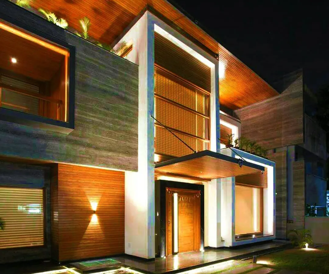 For the "Kohinoor" residence, I employed warm, layered lighting to accentuate the natural textures of stone and wood. The design creates a welcoming yet dramatic entrance, using concealed linear lights and subtle uplighting.