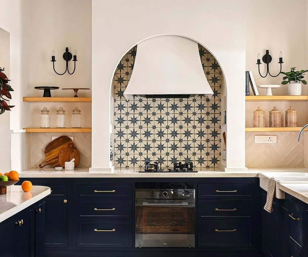 The kitchen is the heart of the home, and I designed this one to be a showstopper. The custom arched range hood, paired with a bold cement tile backsplash, creates a stunning focal point, while the deep blue custom cabinets provide ample, beautiful storage for a space that is as functional as it is breathtaking.
