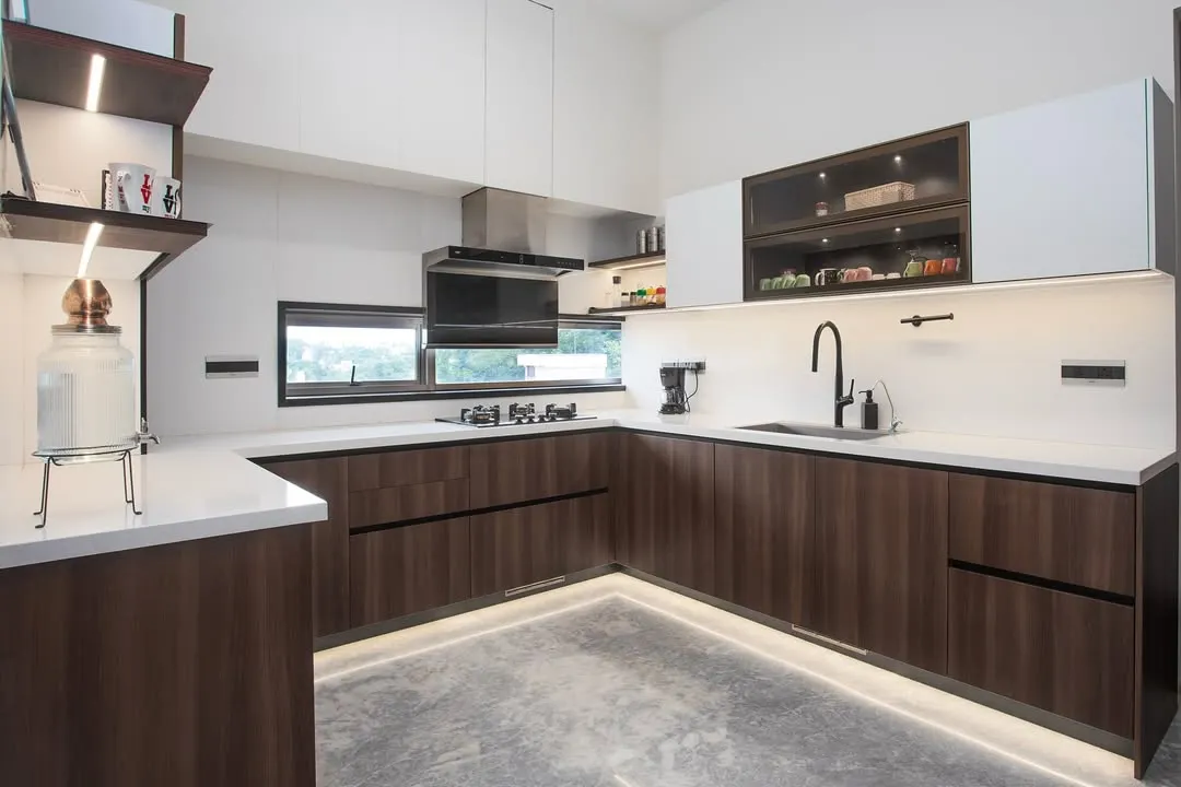 I love combining different textures to create depth. Here, the rich grain of walnut wood on the lower cabinets is balanced by clean, white uppers. The U-shaped layout is a classic for a reason; it makes movement seamless and keeps everything you need within easy reach.