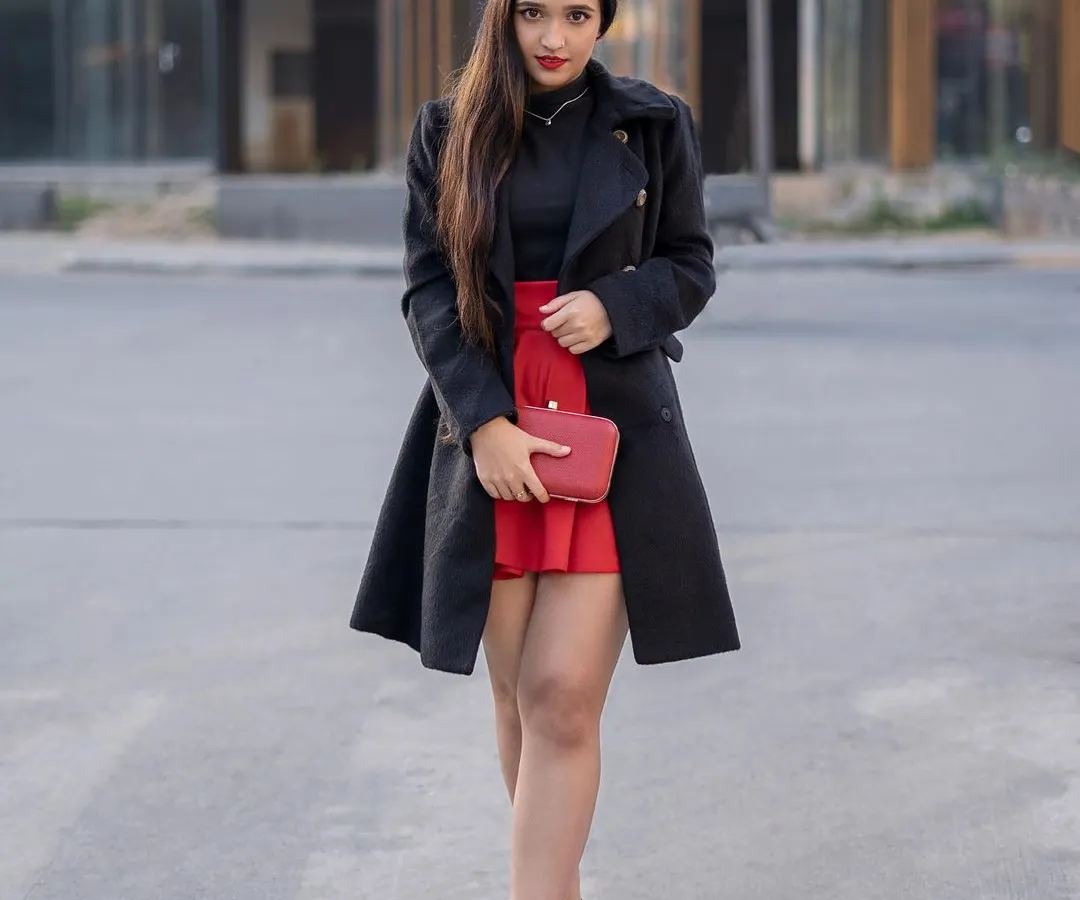 Capturing the chic and effortless 'Emily in Paris' vibe right here on the streets. This shot combines a bold red and black outfit with a modern urban background to create a story of sophisticated style.