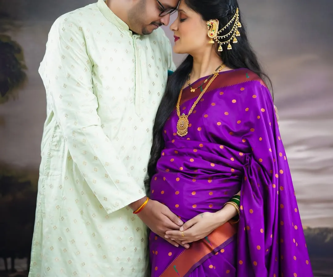 We love capturing the quiet, intimate moments between partners. This traditional maternity portrait, featuring a beautiful purple saree and ethnic jewellery, highlights the deep connection and shared anticipation of welcoming a new life.