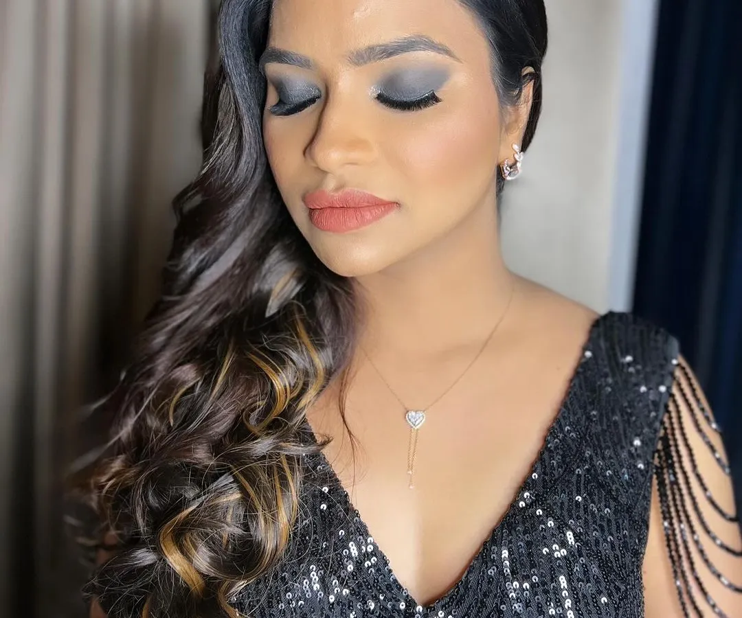A classic smokey eye is perfect for a cocktail party or reception. I created this dramatic yet elegant look using deep charcoal and black shades from MAC, blended for a seamless finish, and paired it with a soft nude lip to keep the focus on her stunning eyes.