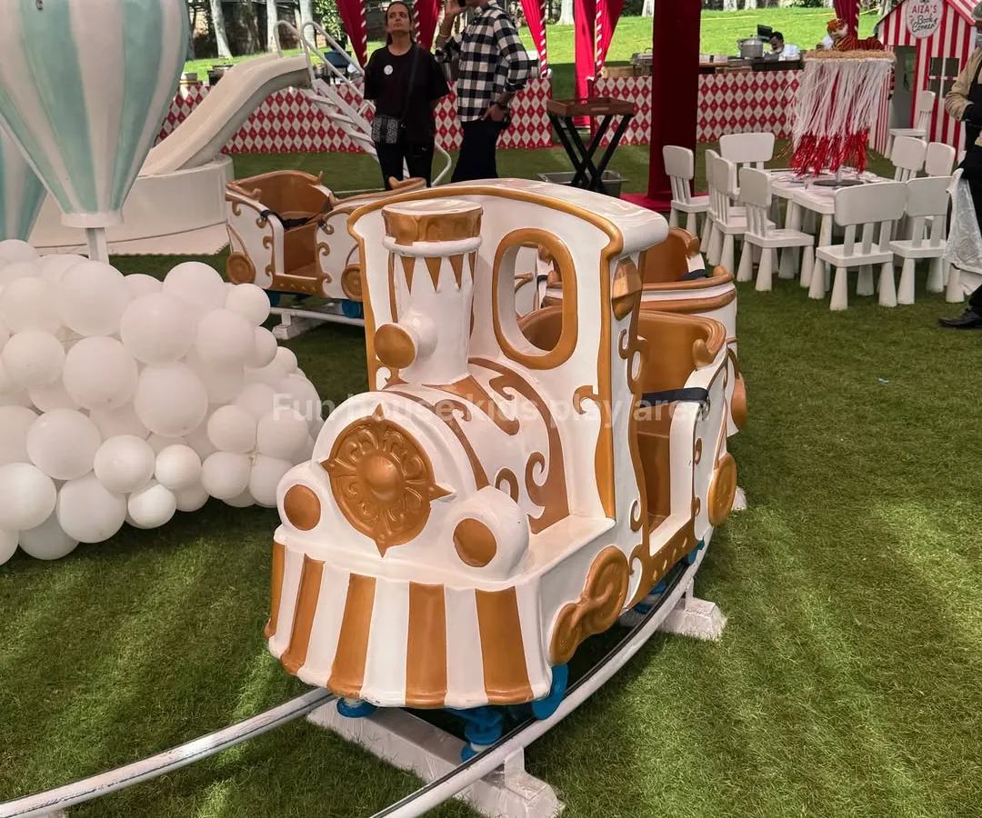 Our elegant white and gold Fun Express train, a centerpiece attraction perfect for circus, carnival, or royal-themed birthday parties. This ride is a guaranteed hit, providing magical moments for children as it circles the track.