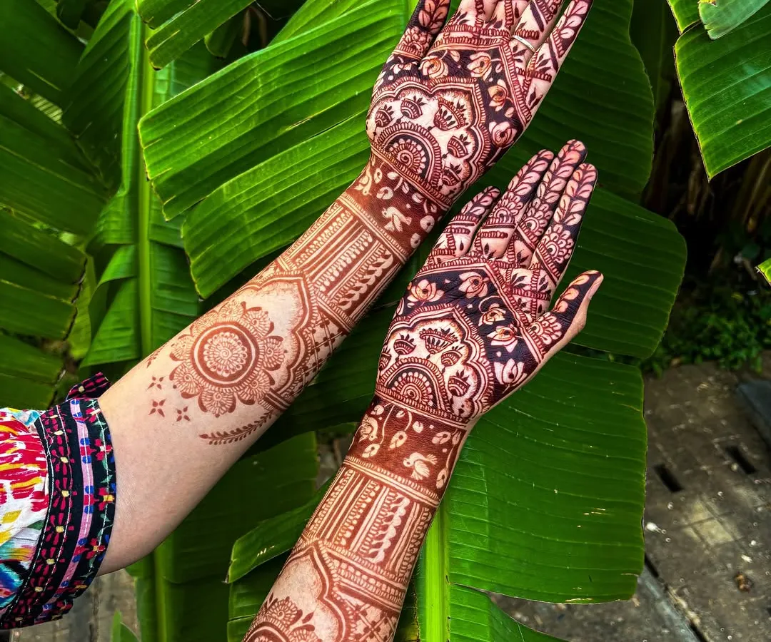 The result of our 100% organic, self-made henna paste. This photo shows the deep, rich maroon stain after it has fully matured, set against a natural backdrop to highlight its true color.