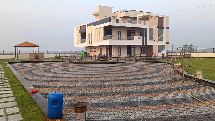 This is a great example of a large-scale paving project using multi-colored cobblestones. I created this intricate circular pattern for a driveway, making a grand entrance for this modern home.