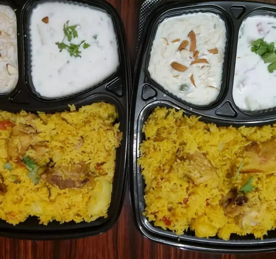 Indulge in our aromatic chicken biryani, prepared by expert home chefs. This complete meal comes with fragrant, long-grain rice and tender chicken, perfectly paired with cooling raita and a delicious sweet side.
