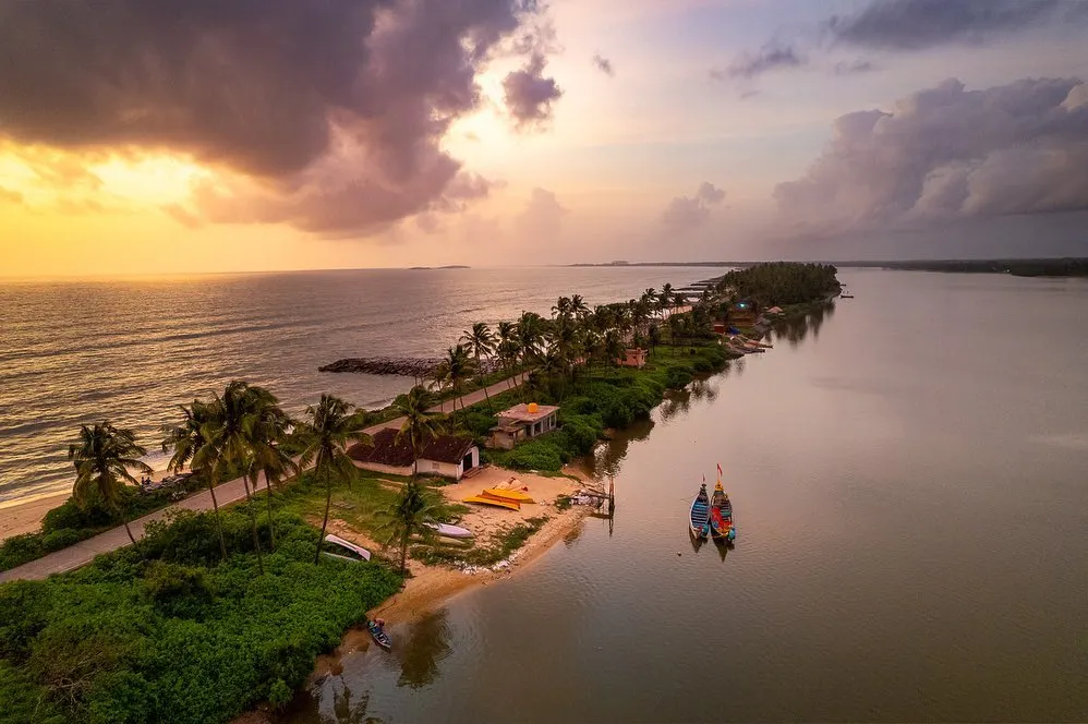 An aerial perspective captures the dramatic meeting of land and water. This thin strip of land, nestled between the serene backwaters and the vast Arabian Sea, showcases the unique coastal geography of Namma Karnataka.