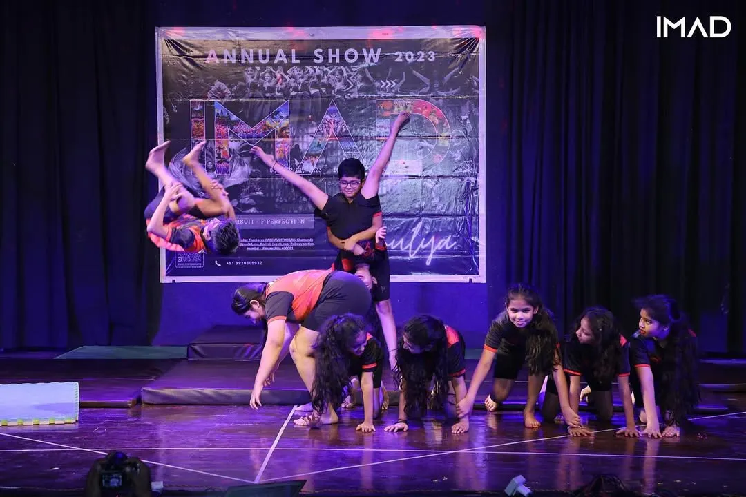 We safely guide our students to master advanced acrobatic skills like this dynamic aerial flip. This moment from our annual showcase captures the power and confidence our young gymnasts develop.