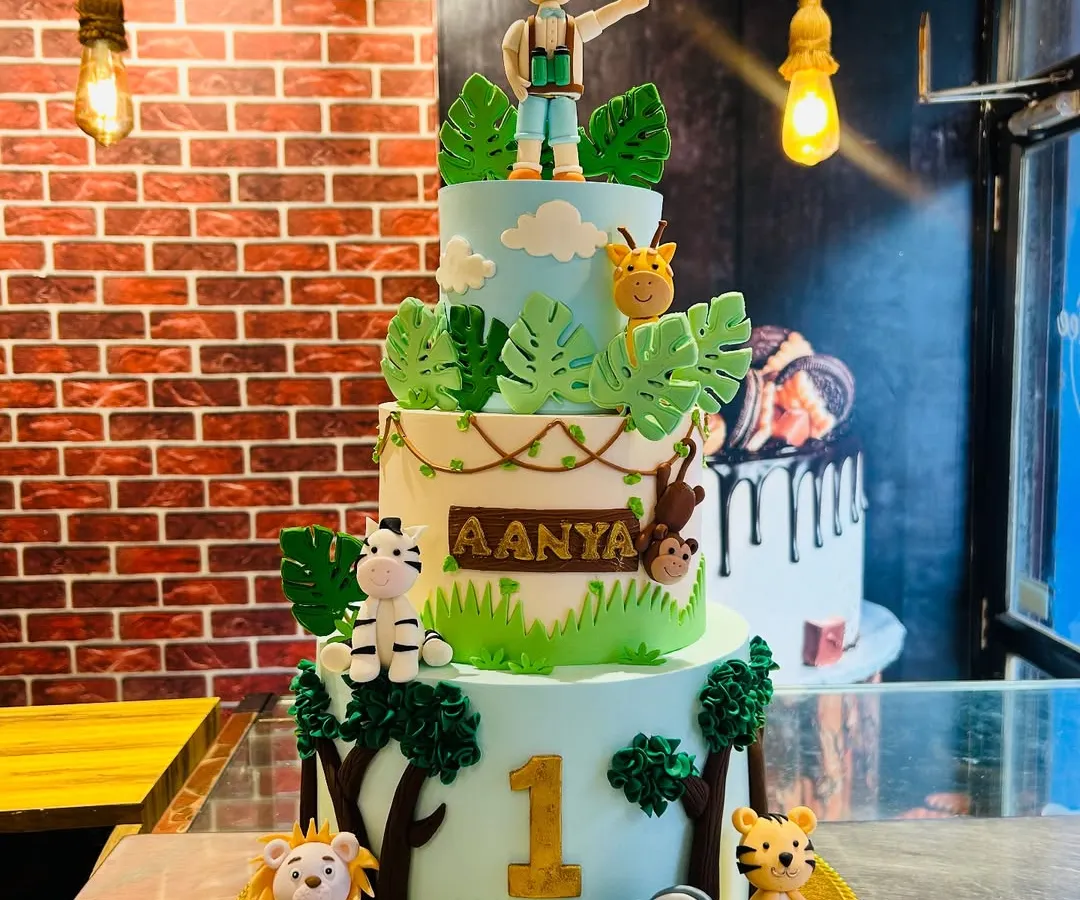 I love bringing big ideas to life, like this towering three-tier jungle safari cake for a first birthday. It features handmade fondant animals like a lion, elephant, and zebra, creating a wild adventure that's completely edible and 100% eggless.