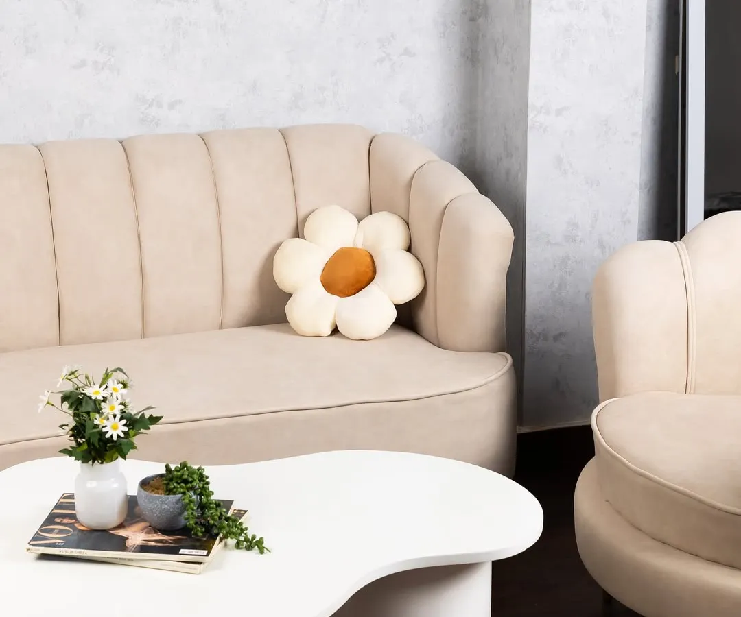 Our lounge area features a beautiful beige fluted sofa and a unique coffee table, creating a chic, ready-to-shoot corner for lifestyle content or client meetings.