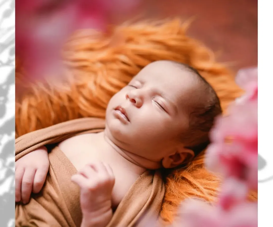 In the quiet moments of sleep, a newborn's purity shines brightest. This is a classic newborn portrait, focusing on the delicate features and serene expression that you will want to remember forever.